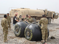 Mike Wunder Helping US Army Ready Two Five Hundred Gallon Collapsible Fuel Drums in Afghanistan
